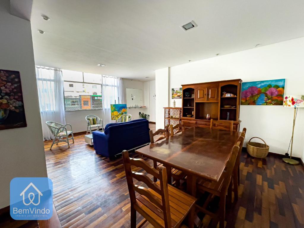 a living room and dining room with a table and chairs at Apartamento completo em frente ao Farol da Barra in Salvador