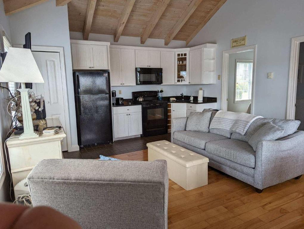 a living room with a couch and a kitchen at Riverview cottage in Edgecomb Sheepscot Harbour Vacation Club Cottage #19 in Edgecomb