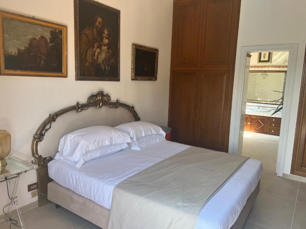 a bedroom with a bed with two pillows on it at Domus Orestea Luxury Suites in Palermo