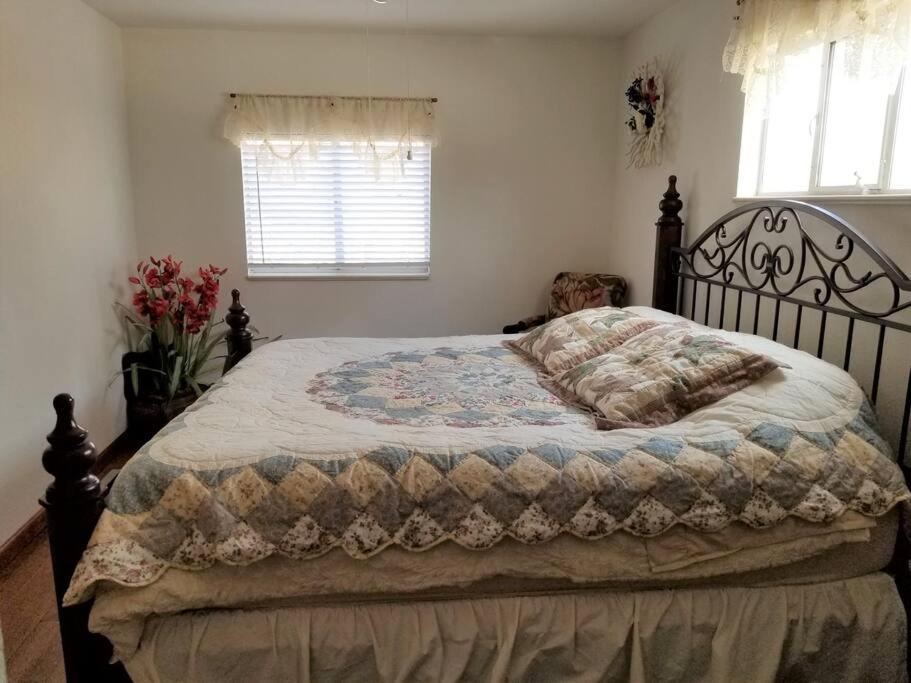 a bed with a quilt on it in a bedroom at Your home in Colorado Springs in Colorado Springs