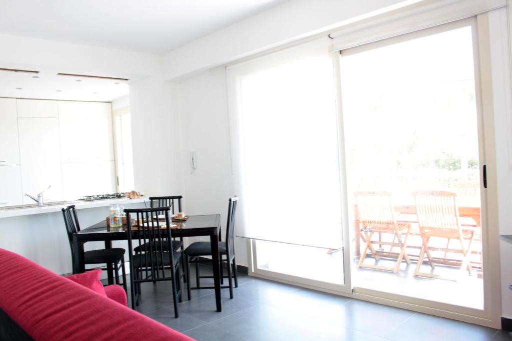 a living room with a table and chairs at The Green Seaside in Fondachello