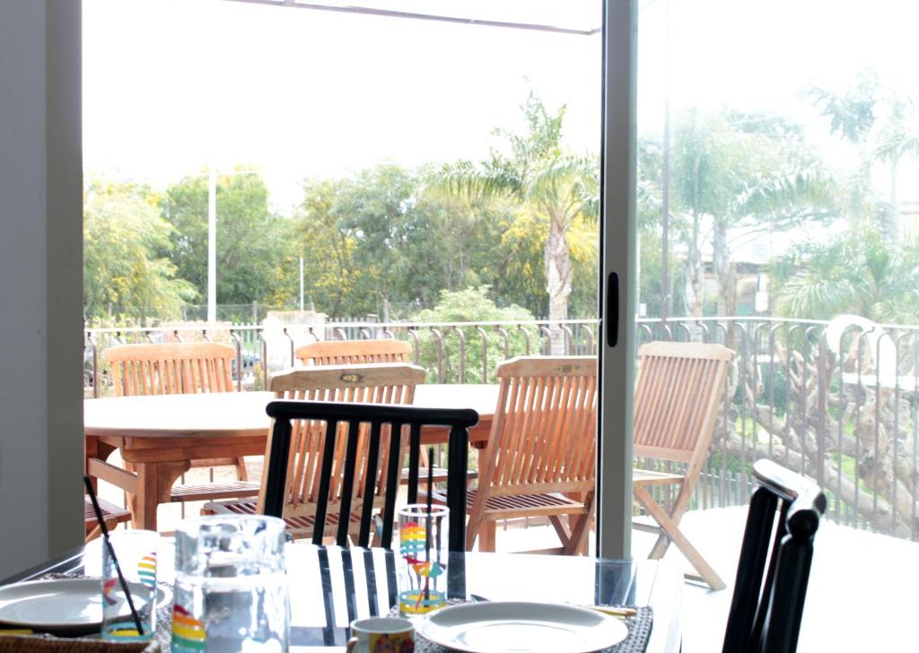 a patio with a table and chairs on a balcony at The Green Seaside in Fondachello