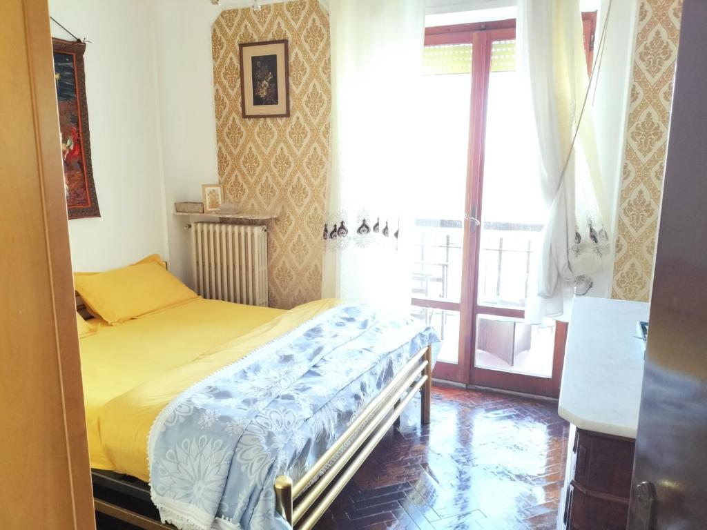 um pequeno quarto com uma cama e uma janela em Le Parasol em Porto San Giorgio