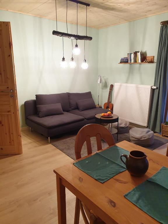 a living room with a couch and a table at Gegenüber der Mühle in Kall