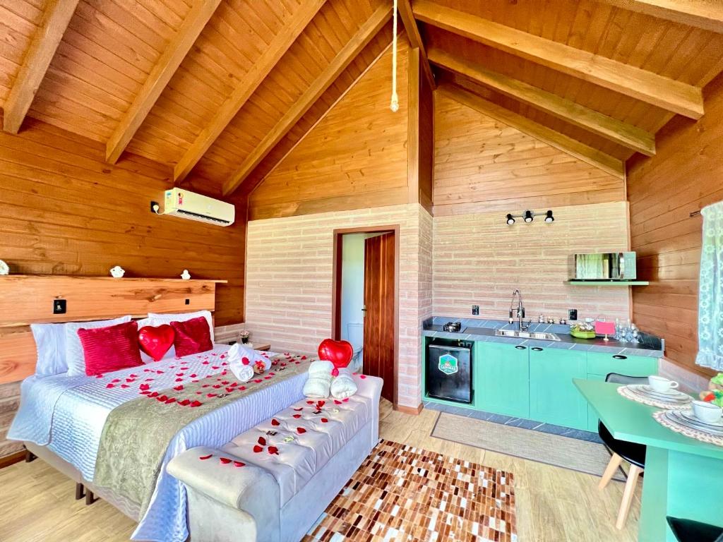 a bedroom with a large bed and a sink at Cabanas Vale Verde in Praia Grande