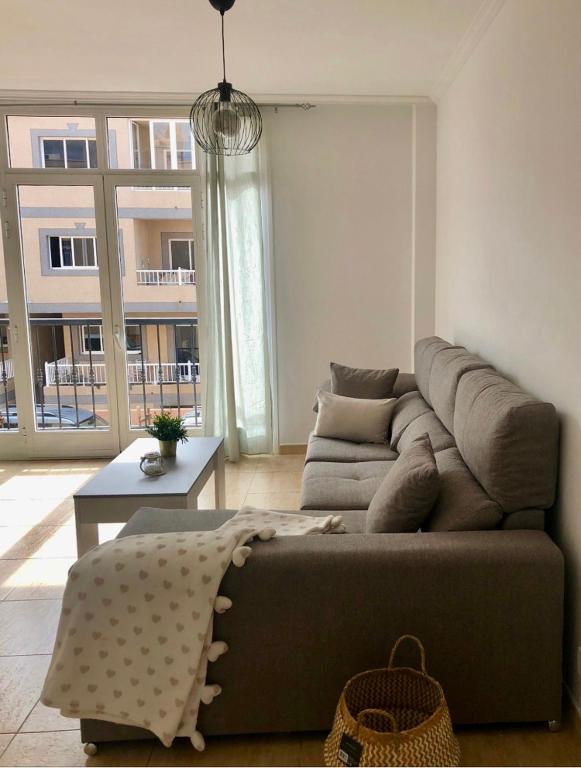a living room with a couch and a table at Light House in Corralejo