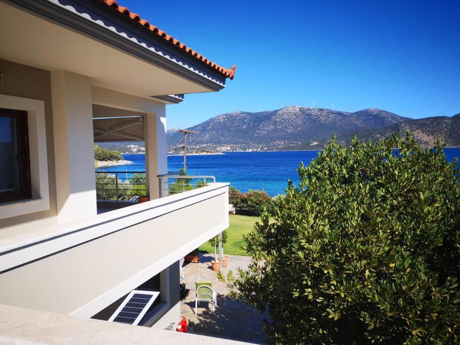 a view of the ocean from the balcony of a house at Villa Marina a breath away from the sea in Áyios Dhimítrios