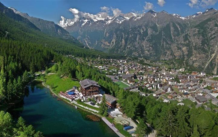 an aerial view of a town next to a river at Pension Aaron am See in Grächen