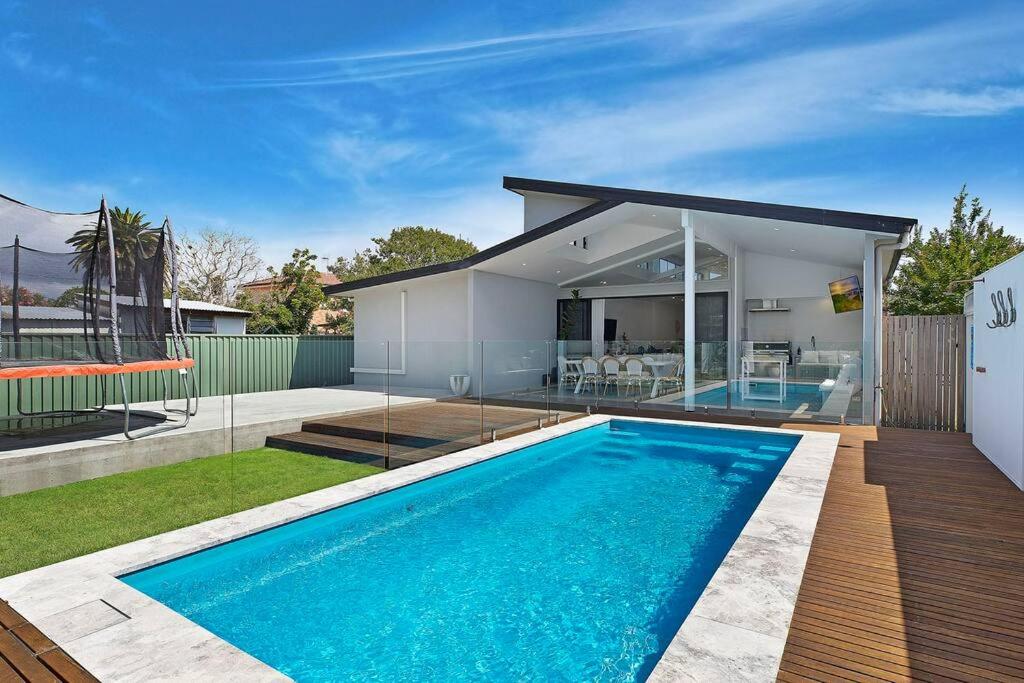 a swimming pool in the backyard of a house at Gorgeous Getaway Toowoon Bay in Long Jetty