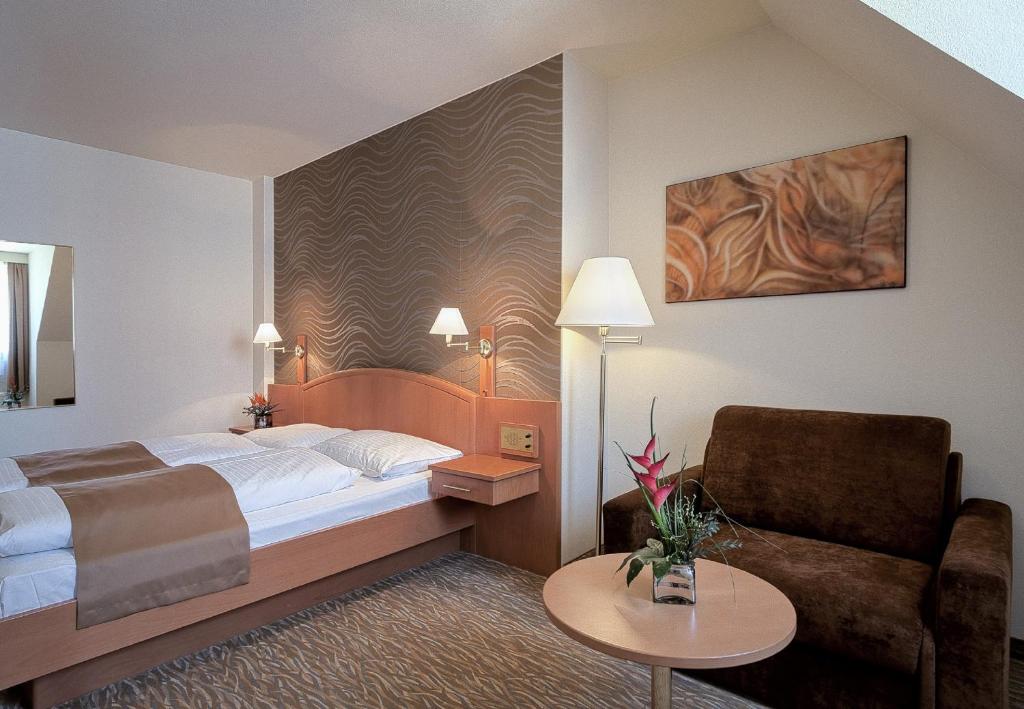 Postel nebo postele na pokoji v ubytování Club Hotel Cortina