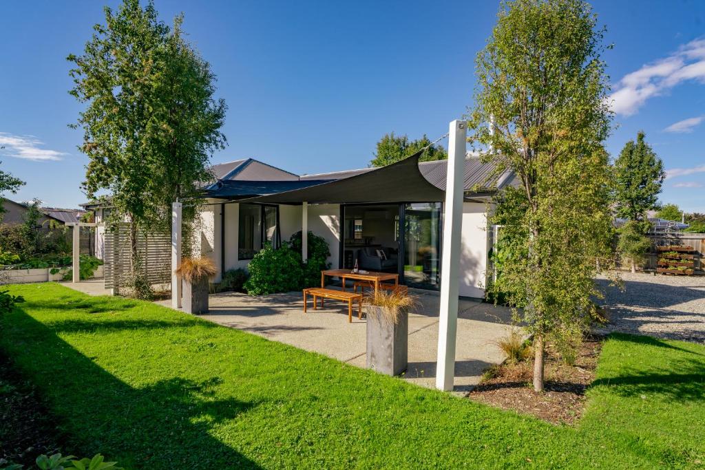 a house with a tent in a yard at Relax on Snowberry - Wanaka Holiday Home in Wanaka