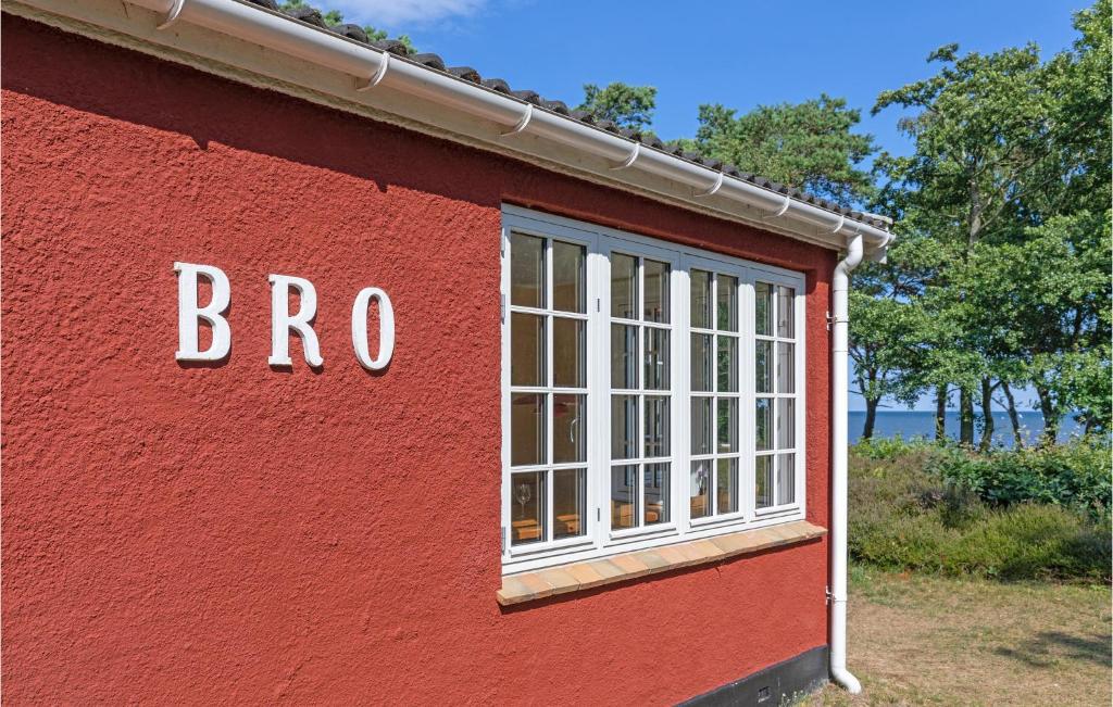 a red building with a window on the side of it at Nice Home In Nexø With Wifi in Neksø