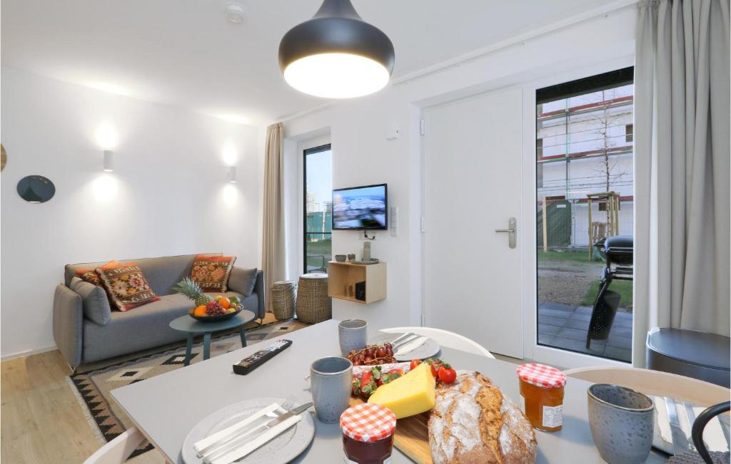 a living room with a table with food on it at Pet Friendly Apartment In Lembruch-dmmer See With Kitchenette in Lembruch