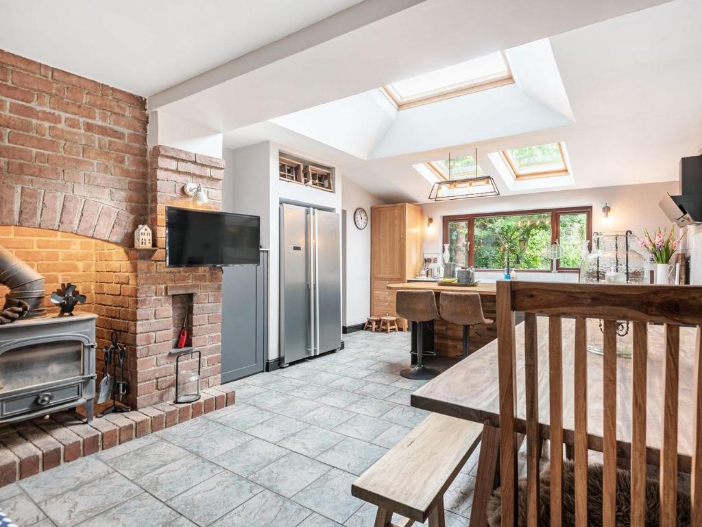 a kitchen and living room with a brick wall at Forge in Newbridge on Wye