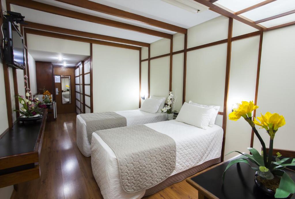 Postel nebo postele na pokoji v ubytování Hotel Nikko
