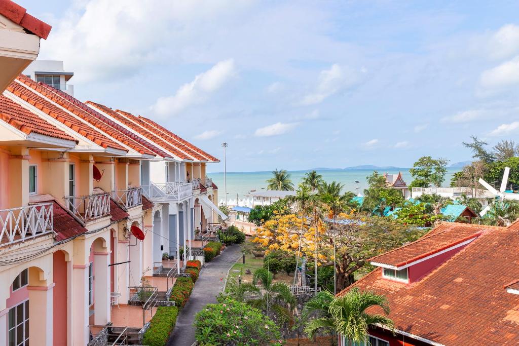 a street in a town with houses and the ocean at Cliff & Beach Villa Phayun in Ban Phayun