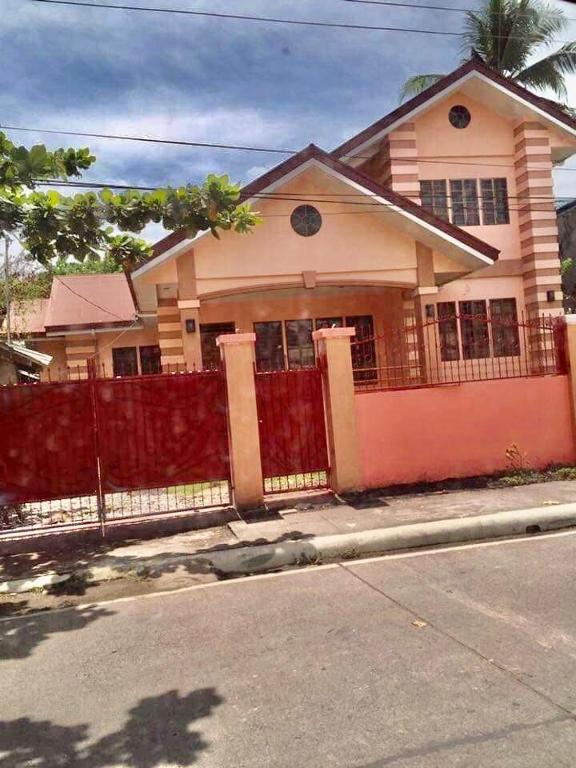 a house with a fence on the side of a street at Josephine's Home Donsol Sorsogon in Donsol