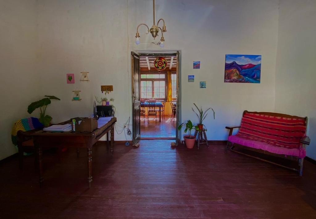 a living room with a couch and a table at Gran Casa Hostel&Camping in Tilcara