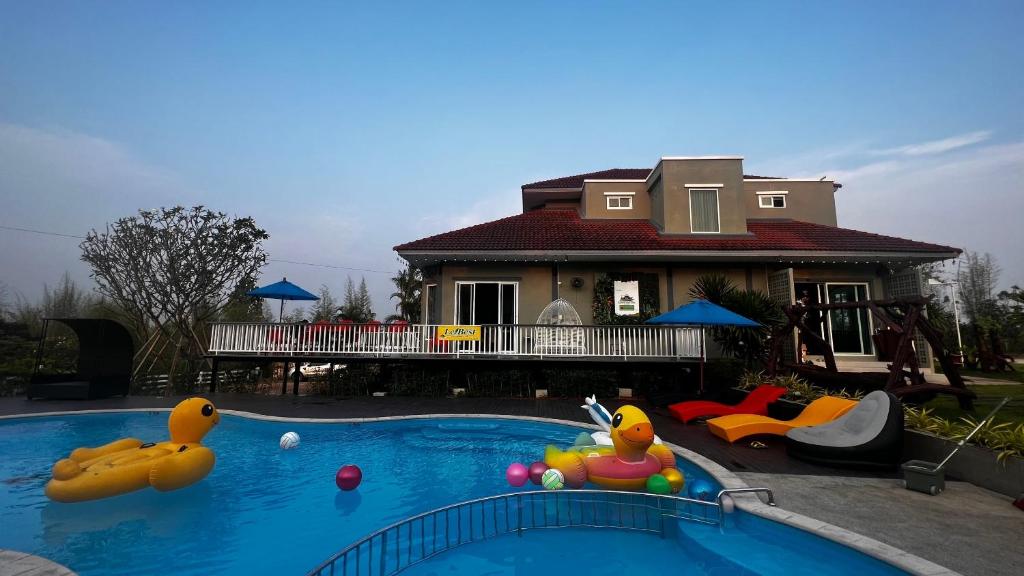 a house with a swimming pool with toys in it at เลอเบสท์พลูวิลล่าเชียงใหม่Lebest Pool Villa Chiangmai in Ban Mai