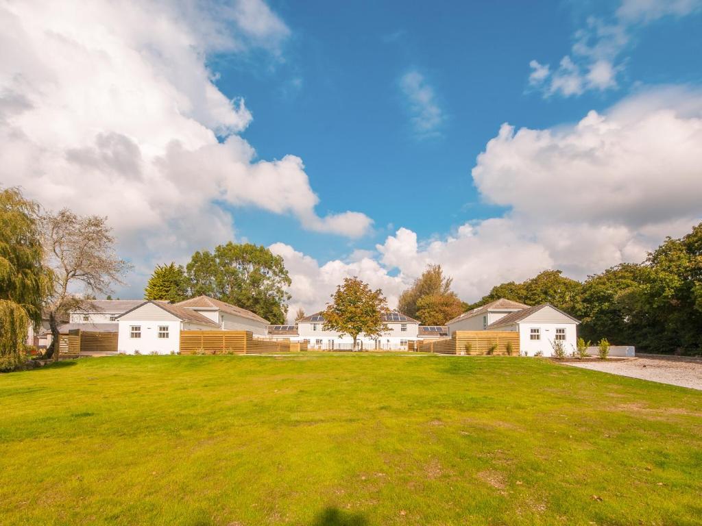 a large yard with houses in the background at Fir Cottage - Uk38485 in Saltash