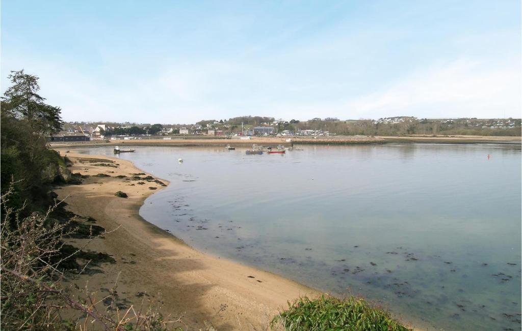 a body of water with a beach and some boats at Awesome Home In Paimpol With Kitchen in Paimpol