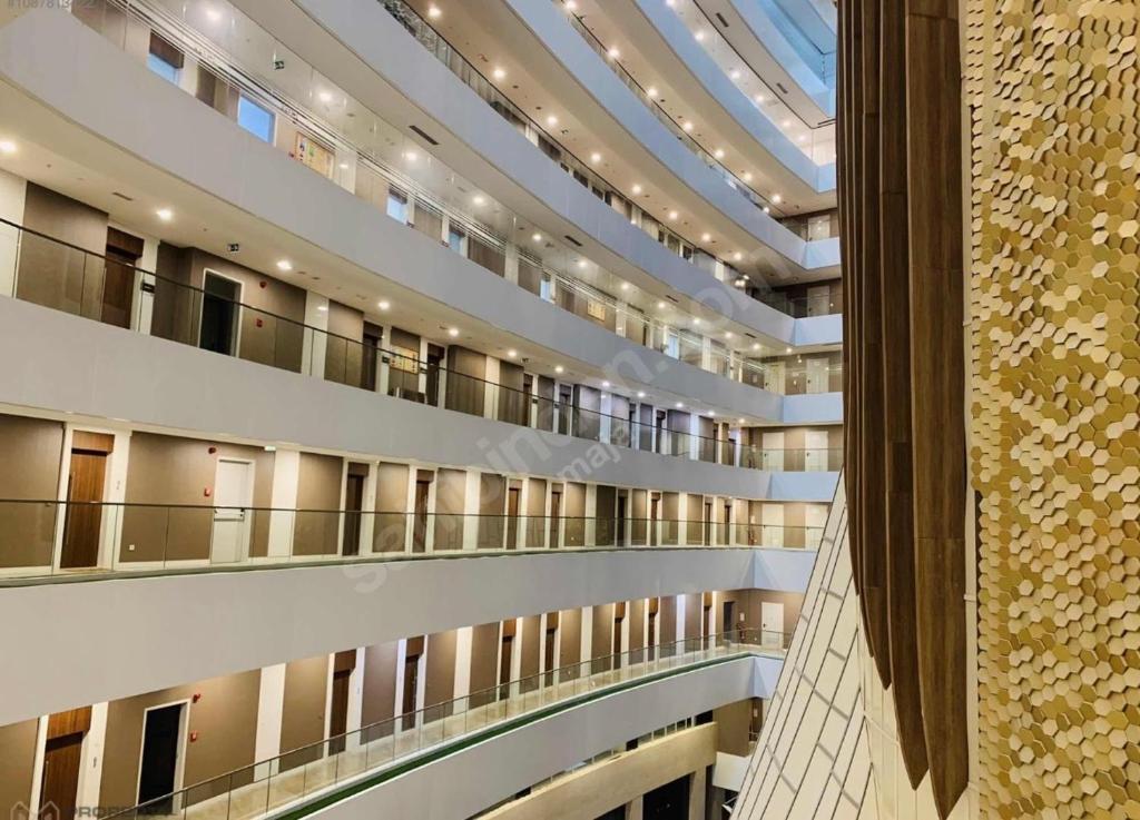 a large building with balconies and a glass ceiling at Luxe Residance in International financial Center, close to watergarden mall in Istanbul