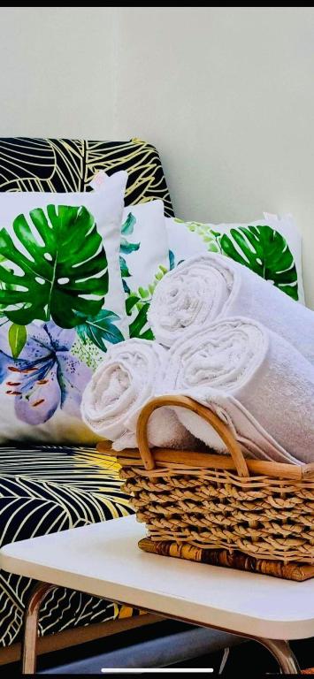 a basket sitting on a bed with towels on it at Field Residence SMDC 1BR w/ Netflix in Manila