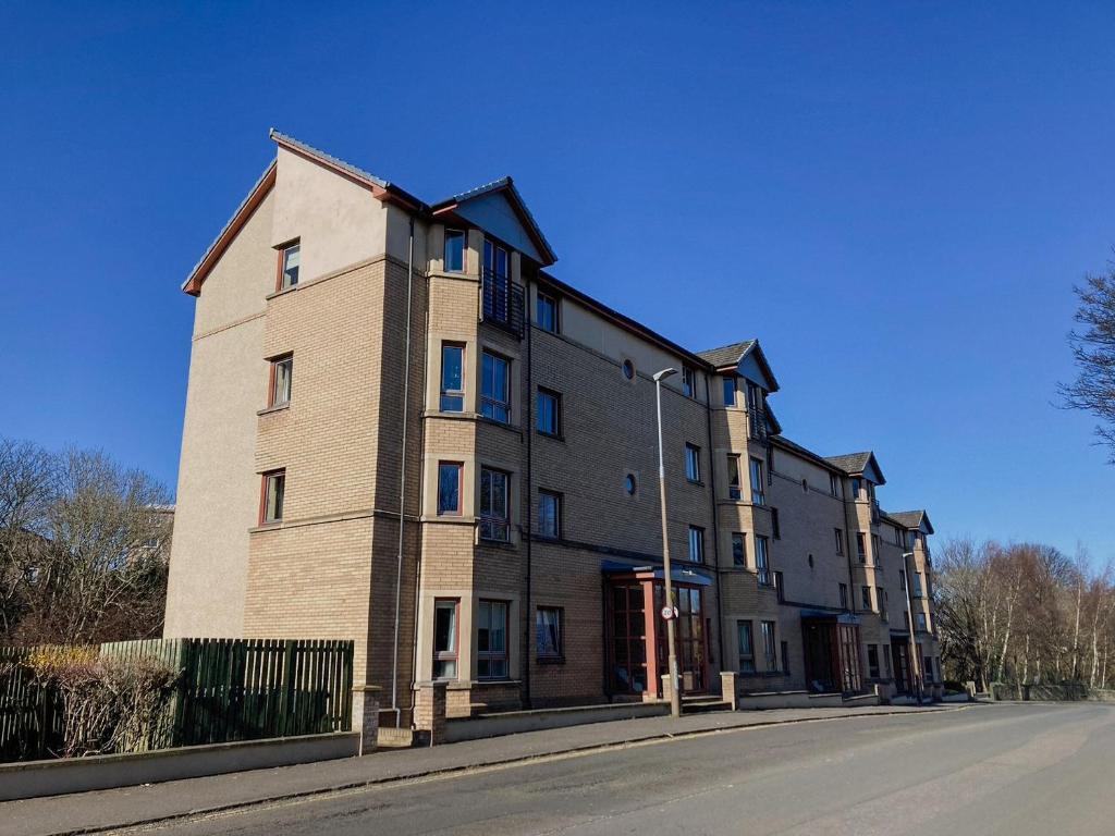 a large brick building on the side of a street at Queens Hill in Edinburgh