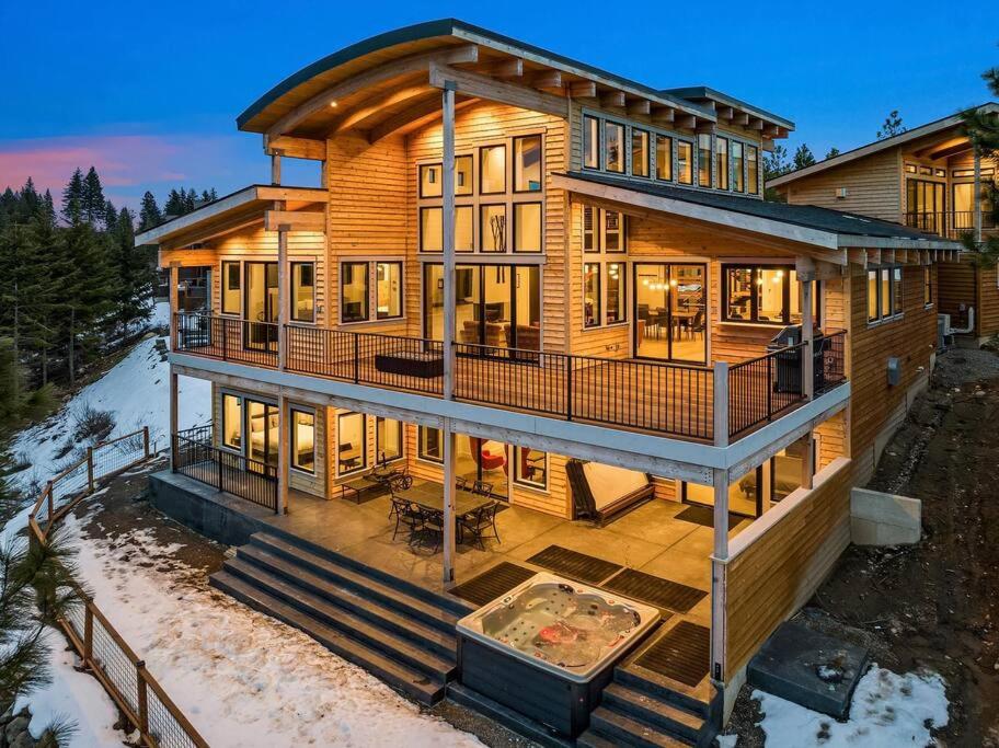 a large wooden house with a deck in the snow at Barrel Ridge at Suncadia in Cle Elum