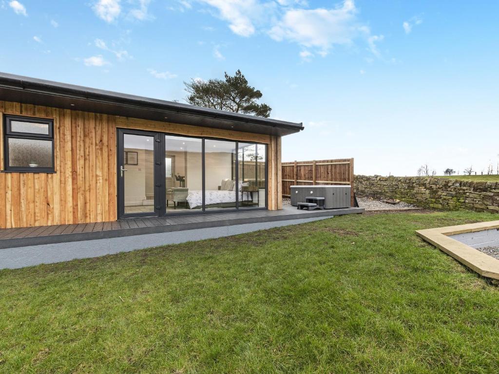 a modern house with glass doors and a yard at The Bunker - Uk40225 in Bardon Mill