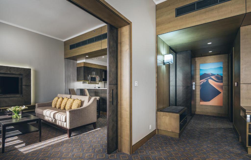a living room with a couch and a table at Ayla Bawadi Hotel & Mall in Al Ain