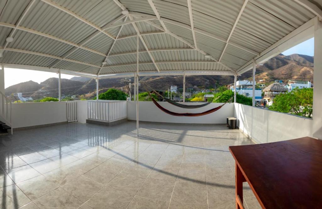 a large room with a roof with a hammock in it at Magic horizont in Taganga