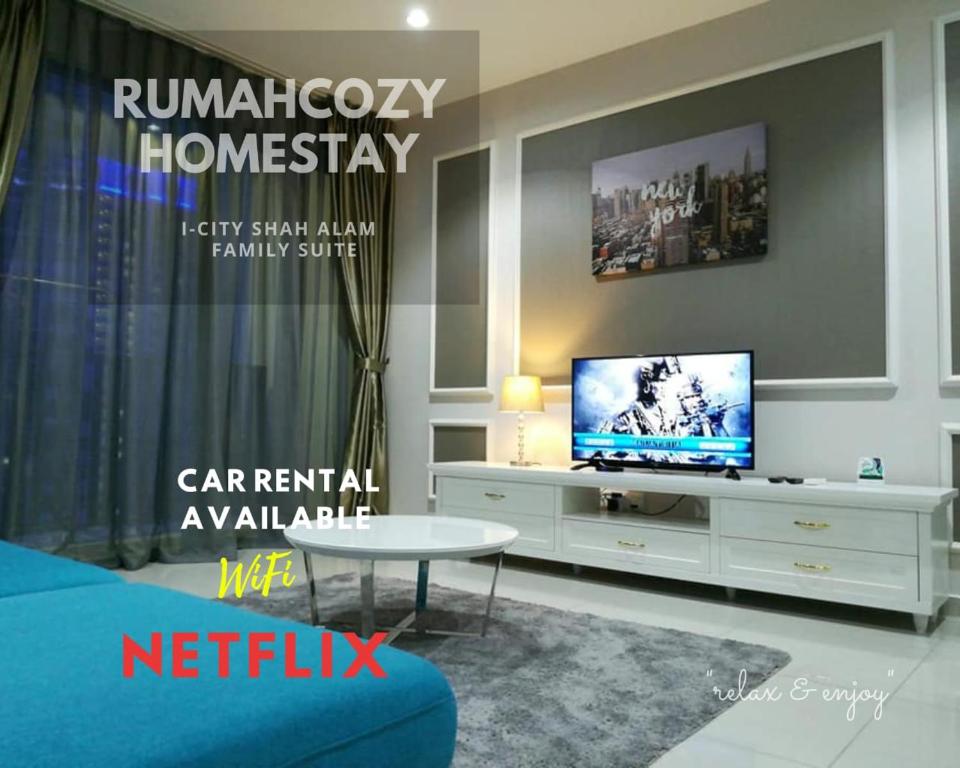 a living room with a tv and a white cabinet at RUMAHCOZY Homestay i-City Shah Alam in Shah Alam