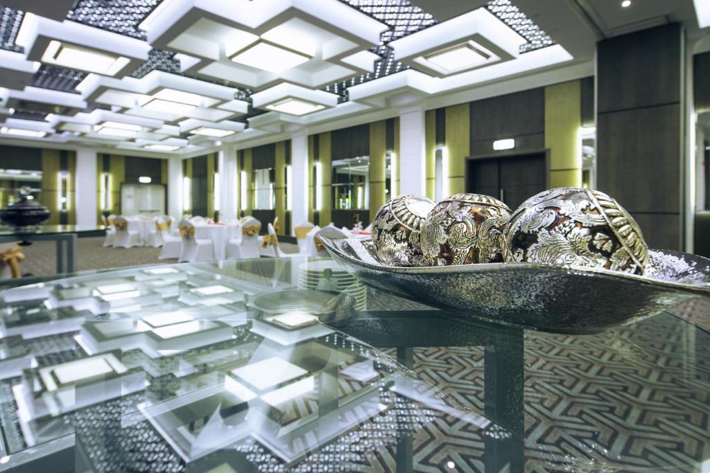 a room with a glass table with balls on it at Ayla Bawadi Hotel & Mall in Al Ain