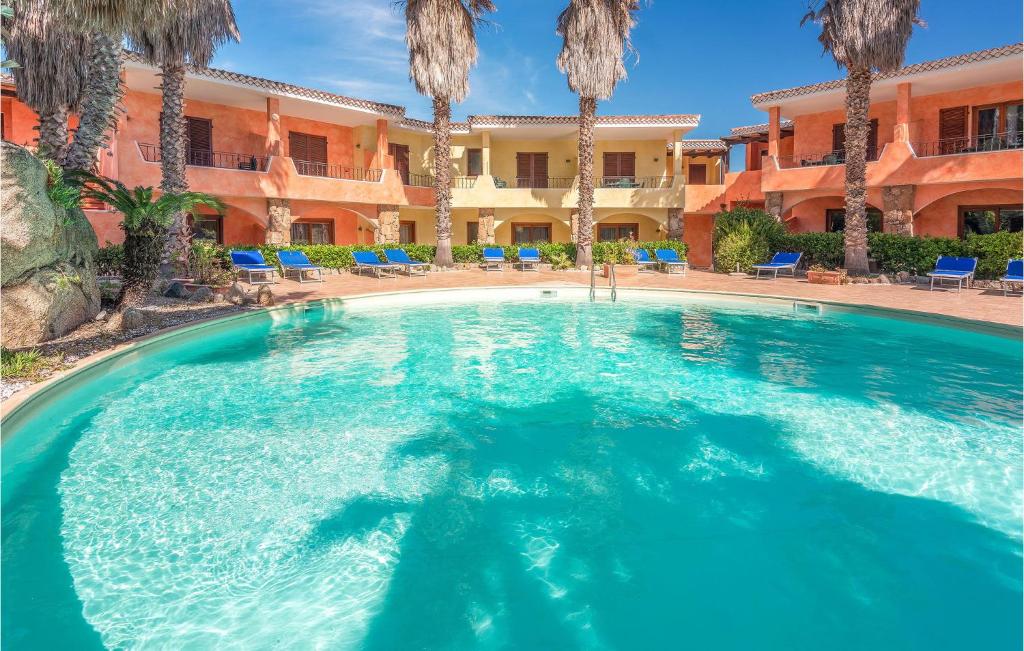 a large swimming pool in a hotel with palm trees at Mono 2 in Palau