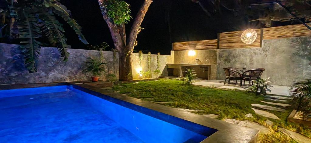 a swimming pool in a backyard at night at Calao Villa, Solar Villa 2 rooms with Private Pool in El Nido