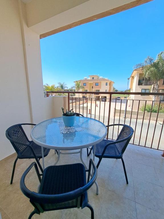 a table and chairs on a balcony with a view at AFRODITI APARTMENTs in Perivolia
