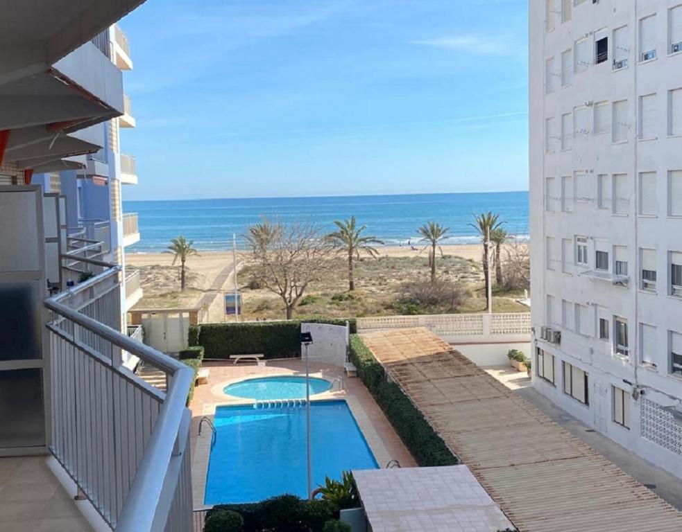 a view of the beach from the balcony of a building at Monela Front beach in Playa de Gandia