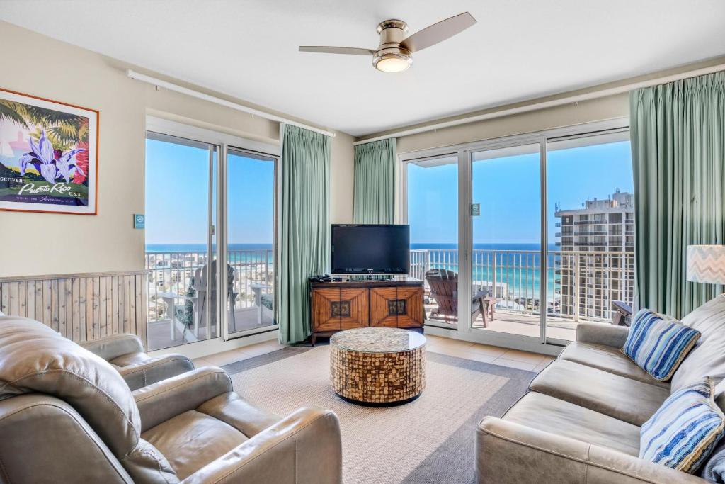 a living room with two couches and a television at Ariel Dunes I 1401 in Destin