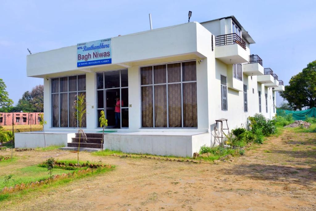 a building with a sign that reads best music at Ranthambhore Bagh Niwas in Sawāi Mādhopur