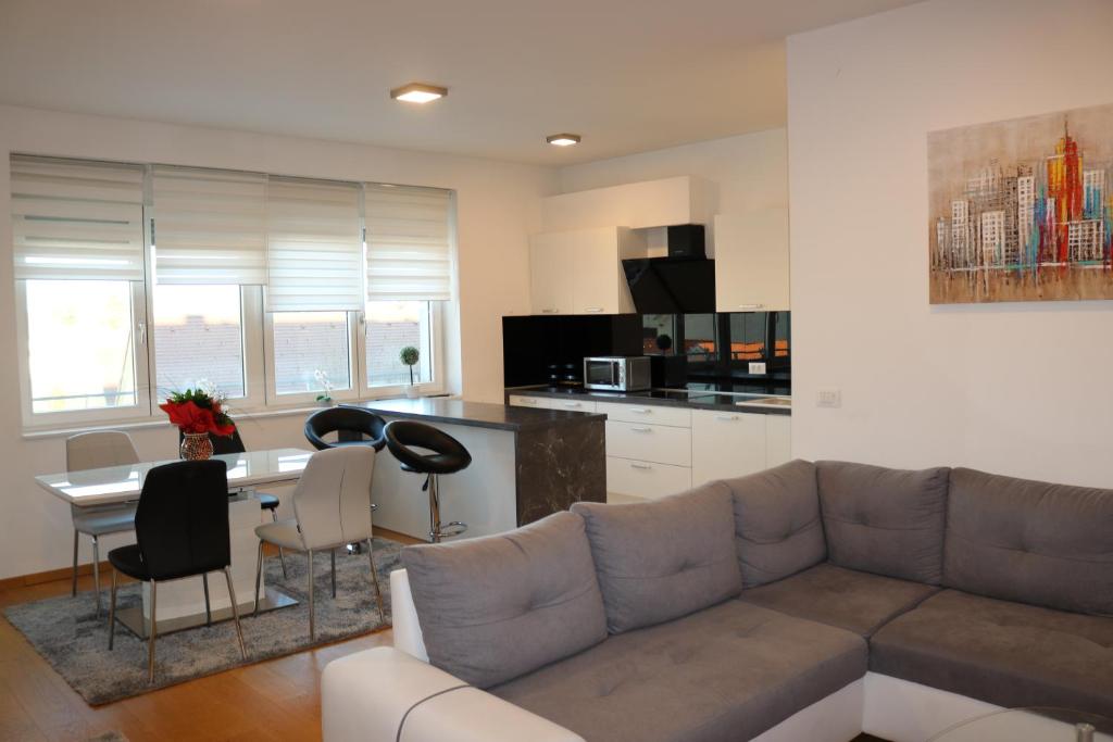 a living room with a couch and a table at Luxury apartment Anabella in Varaždin