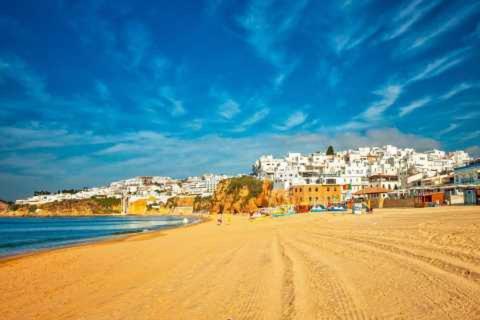 a view of a beach with a town in the background at Residence Pé na Areia in Albufeira