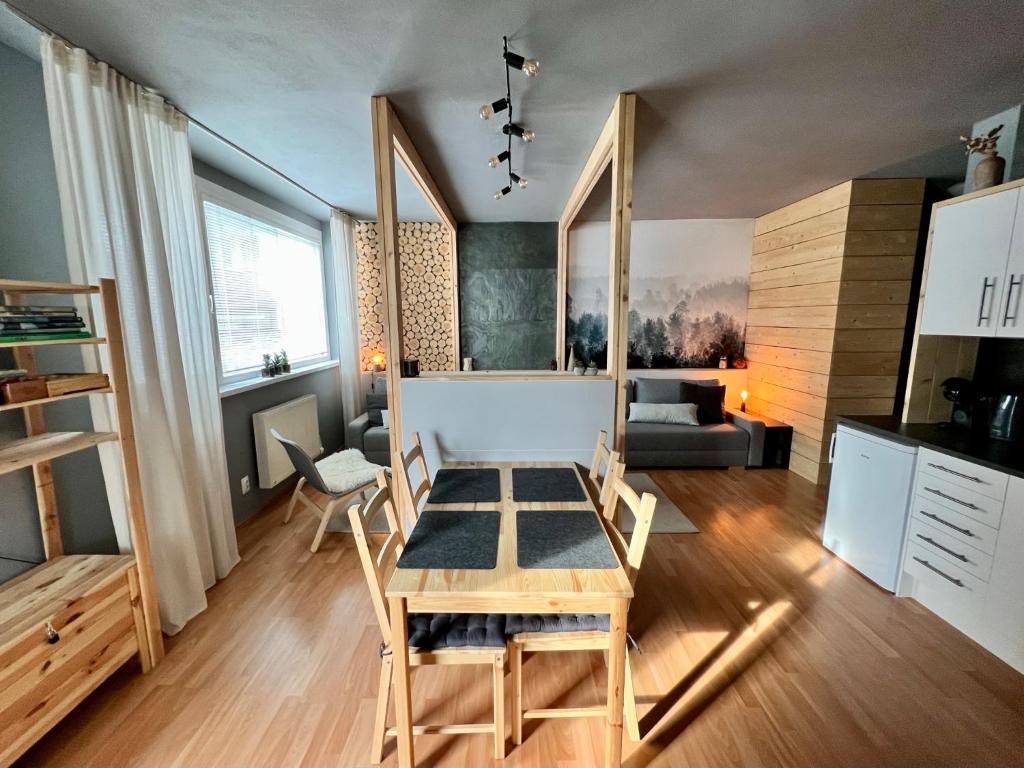 a kitchen and living room with a table and chairs at Apartmán Pinus in Donovaly