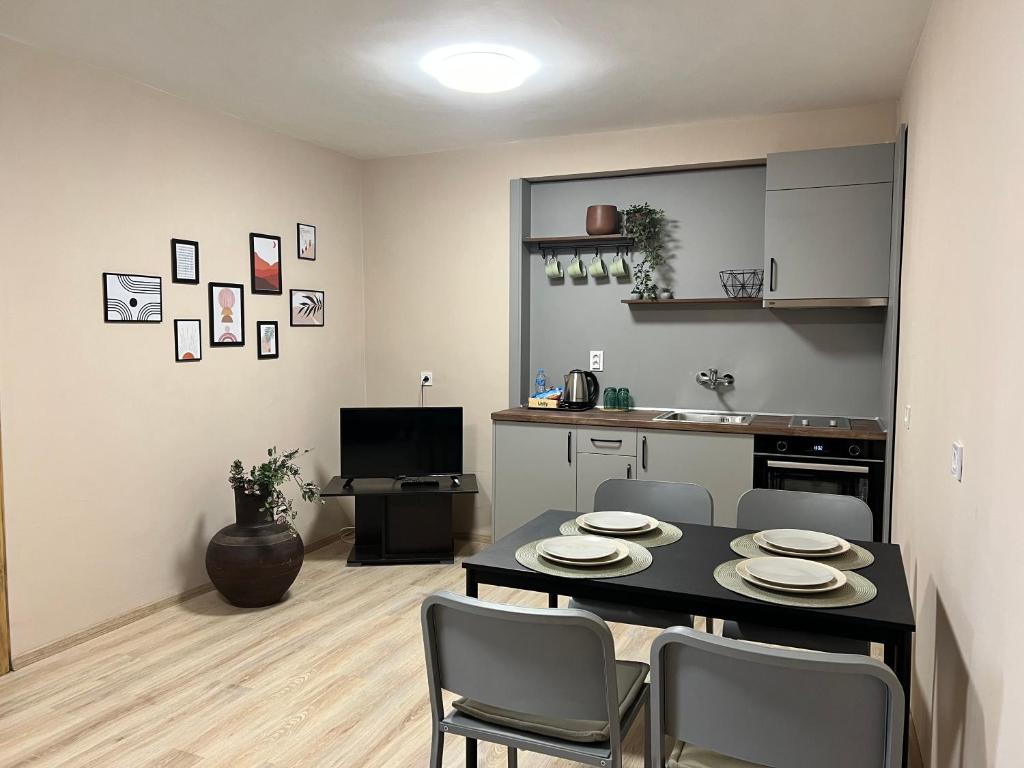 a kitchen and dining room with a table and chairs at Family Hotel Central in Shumen