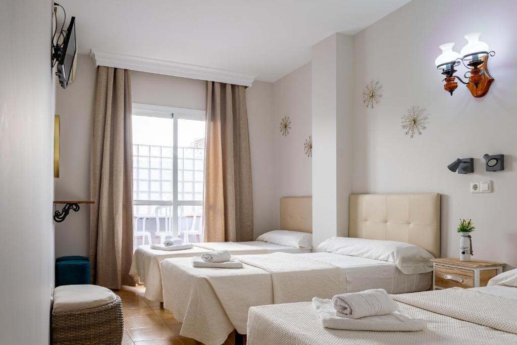 Postel nebo postele na pokoji v ubytování Hostal Cuevas