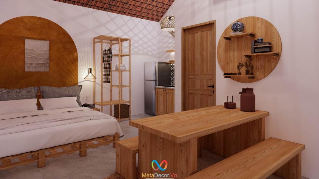 a bedroom with a bed and a table and a refrigerator at Blue Sea Homestay 2 in Phu Yen