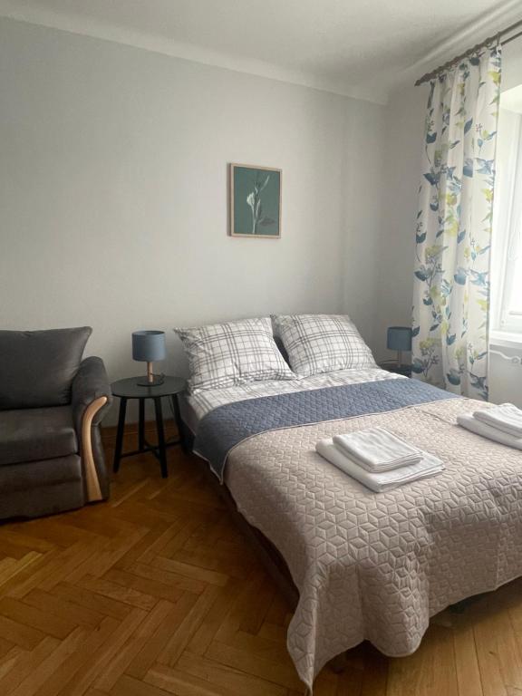um quarto com uma cama e um sofá em Friendly Apartment em Cracóvia