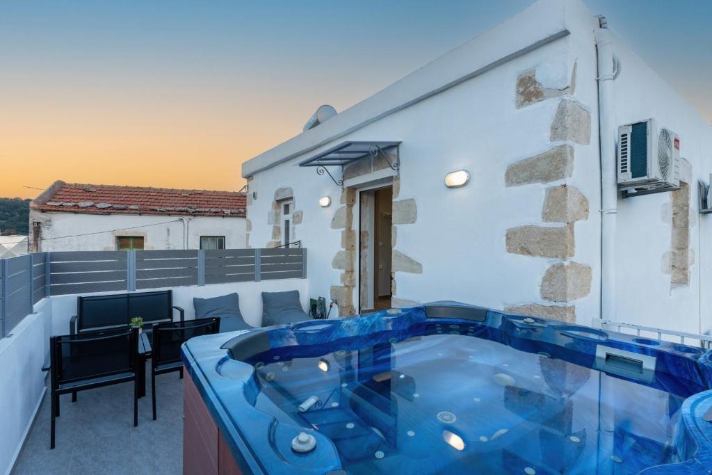 a hot tub on the balcony of a house at Avli Village Home with Outdoor Jacuzzi in Vafés