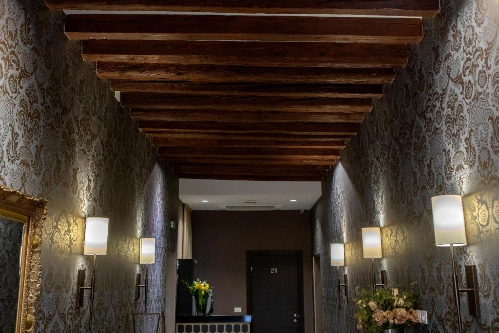 a hallway with a wooden ceiling and two lights at Alle Guglie Boutique Hotel in Venice