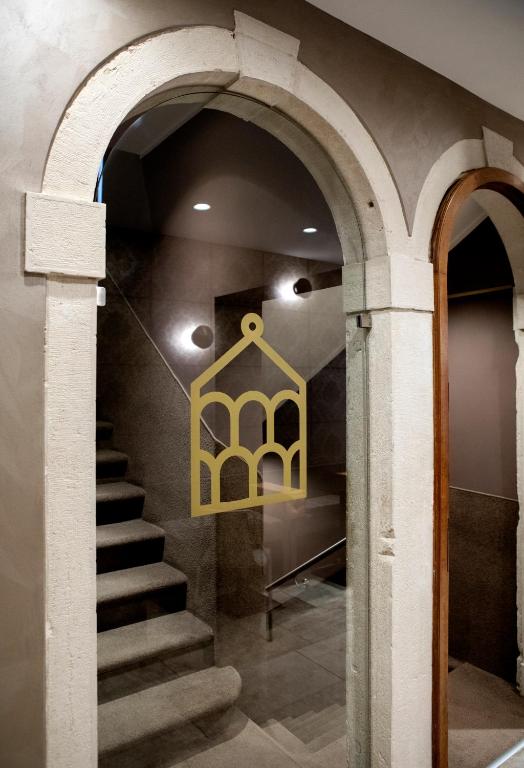 a staircase in a building with a chandelier at Alle Guglie Boutique Hotel in Venice